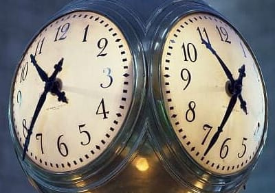 Image of an analog clock with 2 faces.